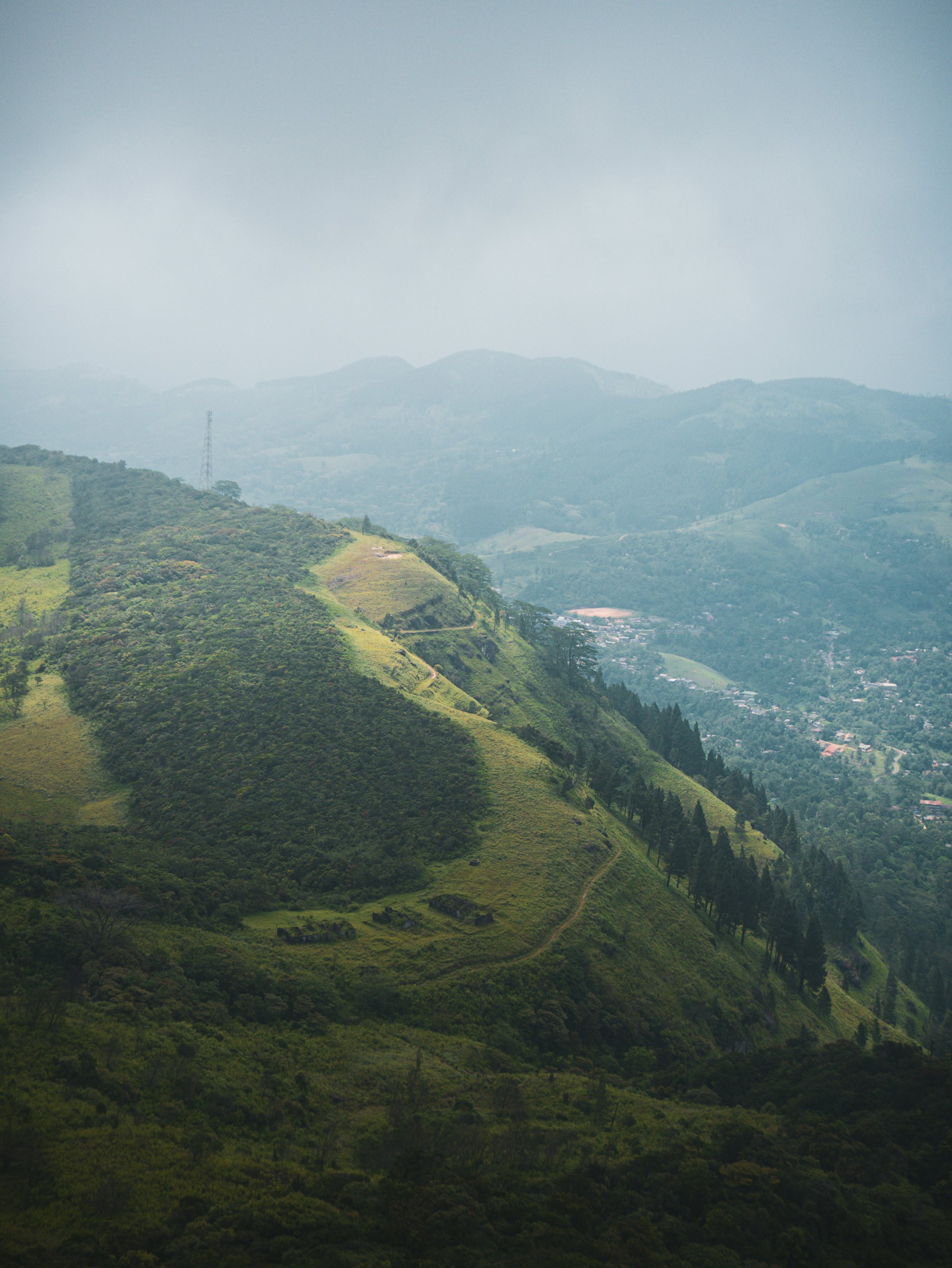Green hills folding away into haze in the Sri Lankan highlands.