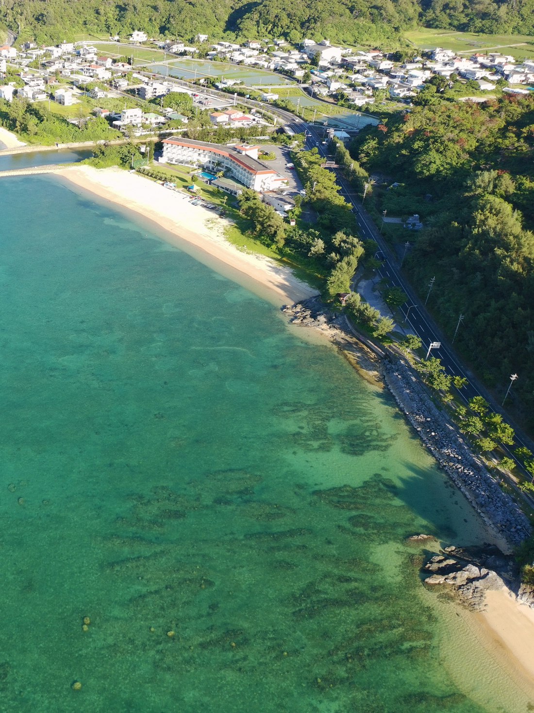 Clear turquoise shallow water meeting pale sand at Pasikudah